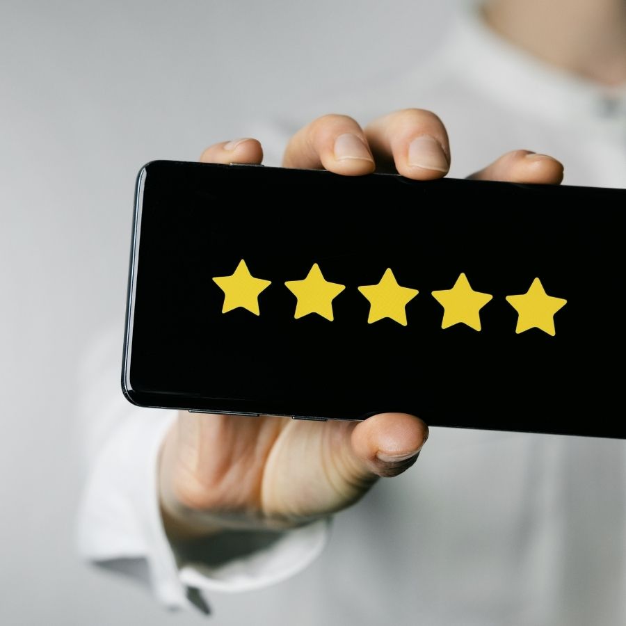 Person holding smartphone showing 5-Star Rating