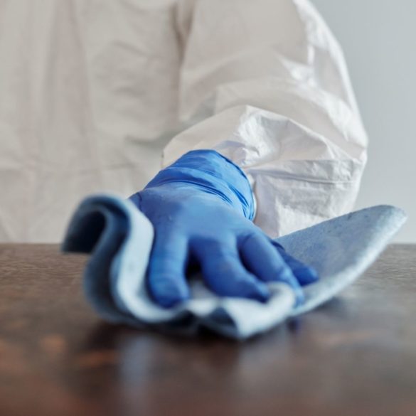 Person with Gloves Cleaning a Surface