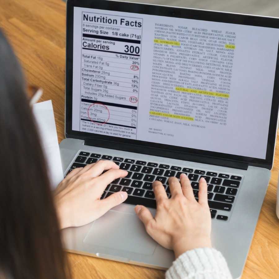 Woman on laptop reviewing nutrition label