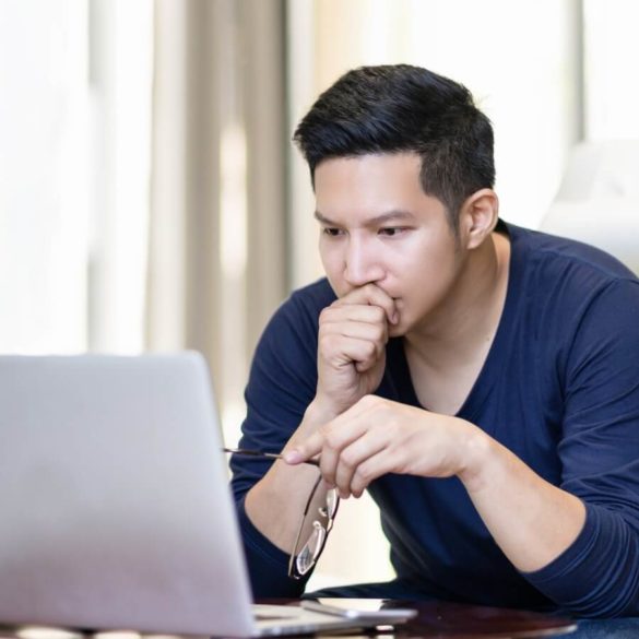 Man at Laptop Looking Concerned